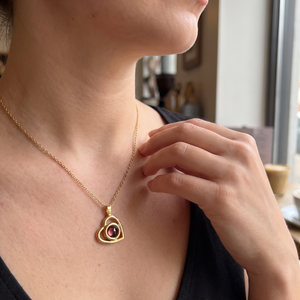 Gold Hidden Photo Necklace worn with a black top in daylight
