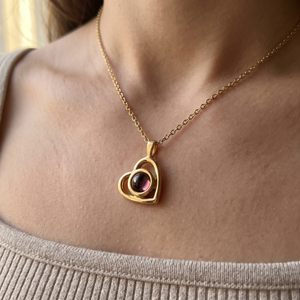 Gold Hidden Photo Necklace worn at the collarbone, the heart pendant resting below the throat
