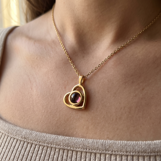 Gold Hidden Photo Necklace worn at the collarbone, the heart pendant resting below the throat