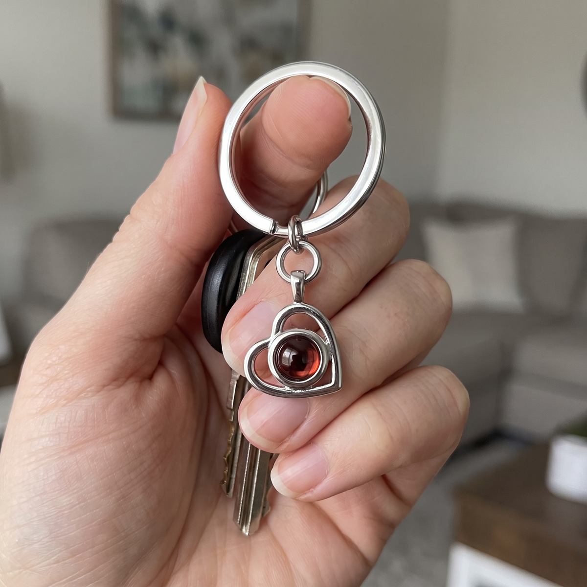 Silver Hidden Photo Keychain held in the hand with house keys