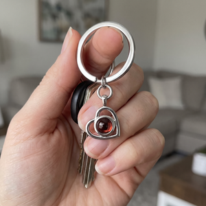 Silver Hidden Photo Keychain held in the hand with house keys